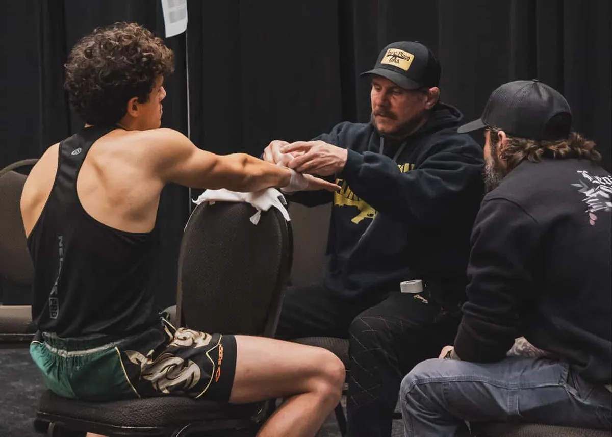 Iron Mike wrapping a fighter's hands before a bout at Furst Place MMA in Hendersonville, Tennessee