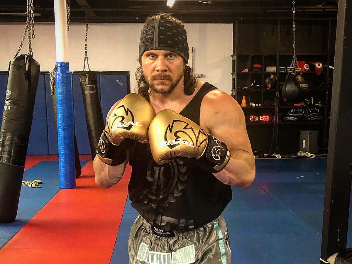 Iron Mike in his fighting stance with gold gloves at Furst Place MMA in Hendersonville, Tennessee