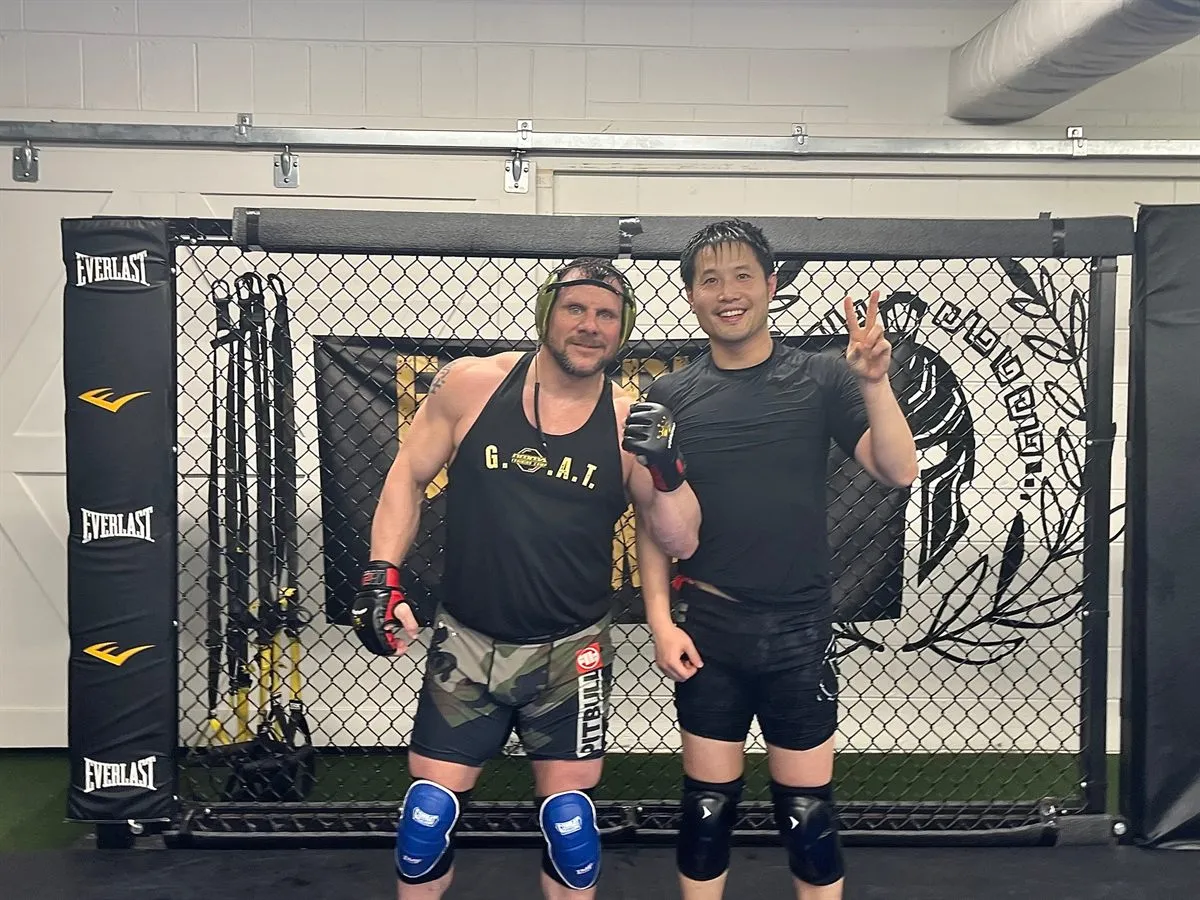 Members training by the cage at Furst Place MMA