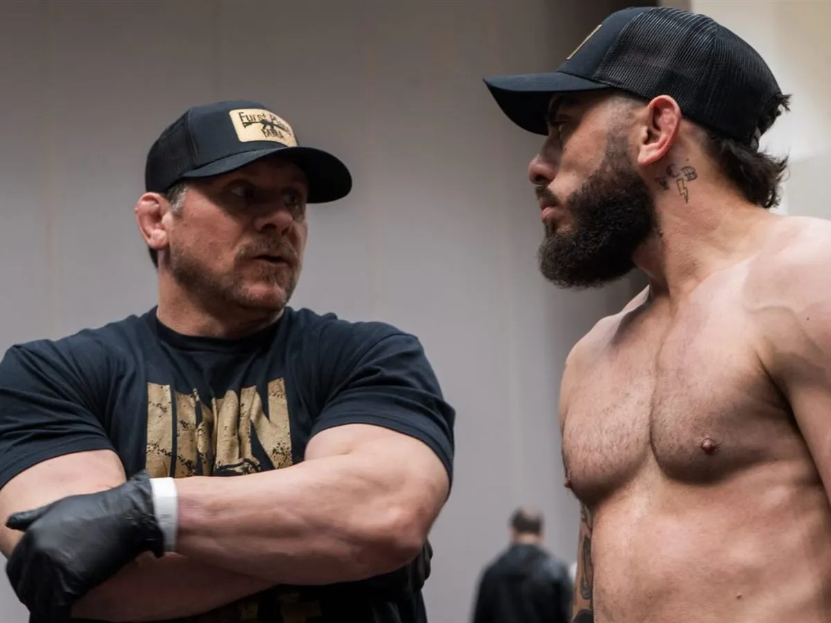 Iron Mike coaching a fighter on technique inside the training cage at Furst Place MMA in Hendersonville, Tennessee