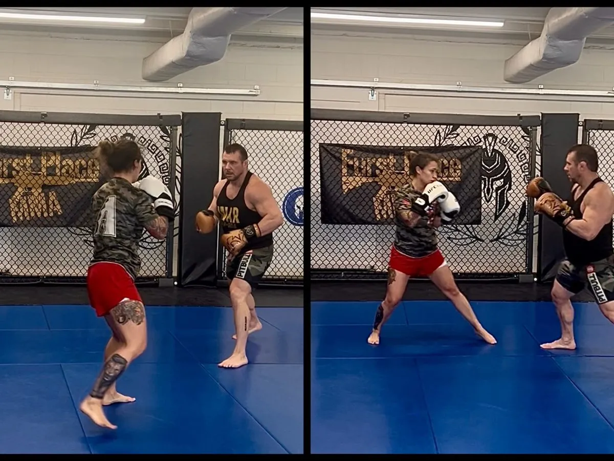 A coach holding pads for a member during striking drills at Furst Place MMA