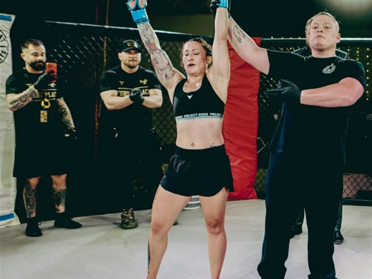 A Furst Place MMA fighter getting her hand raised in victory